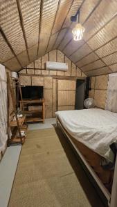 a bedroom with a bed and a table in it at Bamboo Khiri in Sathani Rot Fai