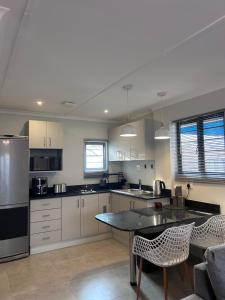 a large kitchen with a table and chairs in it at Whale's Cove in Amanzimtoti