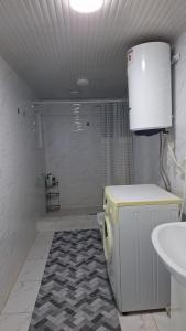 a bathroom with a shower and a sink and a toilet at Guest House Aska Ethno in Kochkorka