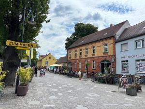 a street in a town with people walking and buildings at Ferienwohnung Grüne Oase in Lübbenau
