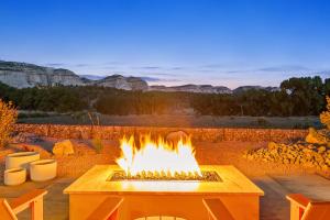 a fire pit with a view of the mountains at ABODE at East Zion in The Fields in Orderville