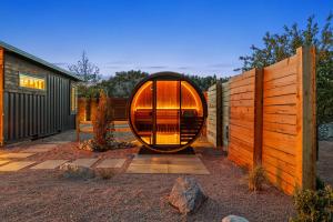 a round house is sitting in a yard next to a fence at ABODE at East Zion in The Fields in Orderville