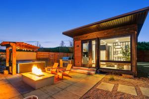 a backyard patio with a fireplace and a house at ABODE at East Zion in The Fields in Orderville