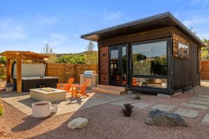 a small cabin with a large window on a patio at ABODE at East Zion in The Fields in Orderville +44 photos