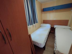 a small room with two beds in it at Falaguera Bungalow 5 in Bárig +10 photos