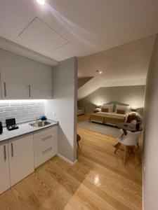 a kitchen and living room with a bed in the background at PIER HOUSE Accommodation in Funchal