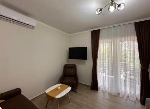 a living room with a couch and a chair at Luxury Apartment with Sea View & Heated pool in Kotor