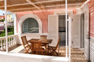 a patio with a table and chairs on a balcony at Maridea - Il Borgo in Ponza