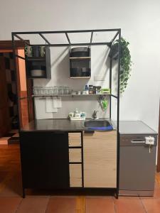 a small kitchen with a counter and a sink at El Oasis Canario in Tacoronte