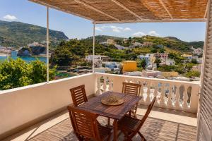 a table and chairs on a balcony with a view at Maridea - Il Borgo in Ponza