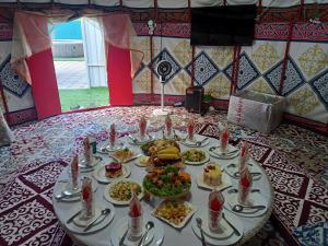 a table with a bunch of food on it at Laguna Relax in Balqash