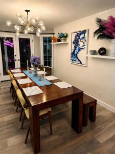 a dining room with a long wooden table and chairs at Mountain Daddies Boutique Bed & Breakfast near Yosemite - Fresh Homemade Breakfast Included in Oakhurst