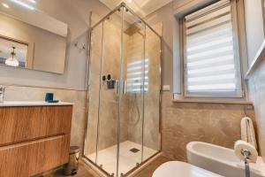 a bathroom with a shower and a sink at My Tuscany Turquoise Suite in San Quirico dʼOrcia