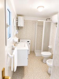 a white bathroom with a toilet and a sink at Maridea - Il Borgo in Ponza +36 photos