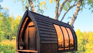 a small wooden house with a large window at The Perfect Stop - Viking Haven in Lødingen +3 photos