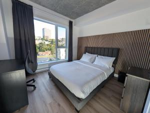 a bedroom with a bed and a large window at Suites Cobalt in Quebec City +23 photos