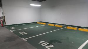 a gymnasium with a tennis court with numbers on it at شقة مصدر in Abu Dhabi +6 photos
