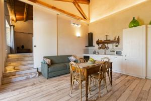 a living room with a table and a couch at Mulino 1220 in Scopello