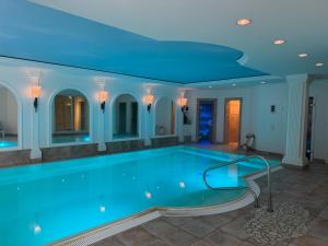 a swimming pool with a blue ceiling at Villa Löwe - Heated Indoor Pool, Spa & Wellness Estate near Basel in Kandern