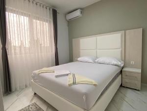 a bedroom with a large white bed and a window at Maxhuri Apartments in Ulcinj +66 photos