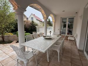 a white table and chairs on a patio at Villa Löwe - Heated Indoor Pool, Spa & Wellness Estate near Basel in Kandern