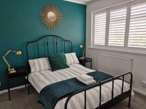 a bedroom with a bed with a mirror on the wall at Seaside House Broadstairs by the Beach with Parking in Broadstairs