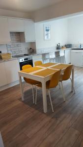 a kitchen with a table and chairs in a kitchen at Seaside House Broadstairs by the Beach with Parking in Broadstairs +27 photos