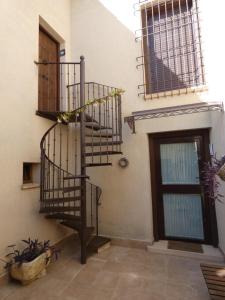 a room with a spiral staircase next to a door at Casa Rural Bellamonte in Belmonte