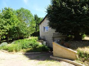 a stone house with a window and a tree at La Maison d Ingrandes - relais Valami in Ingrandes-de-Touraine