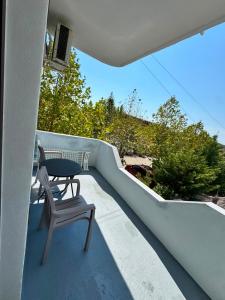 a table and a chair on a balcony at ApartHotel Fahria Velipoje in Velipojë