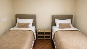 two beds sitting next to each other in a room at Refúgio das Rosas in Pedro do Rio +21 photos