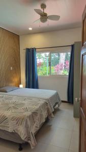 a bedroom with a bed and a large window at Villas Pura Vida - Mango in Puntarenas +33 photos