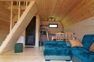 a living room with a blue couch in a cabin at Elia Hut Kazbegi in Kazbegi