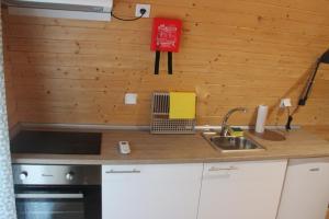 a kitchen with a sink and a counter top at Montejunto Bungalows in Cadaval