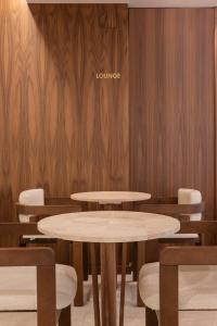 a table and chairs in a room with wooden walls at Anthem Suites & Spa in Athens +146 photos