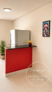 a kitchen with a red counter and a refrigerator at Pousada Horizontes de Bonito in Bonito +13 photos