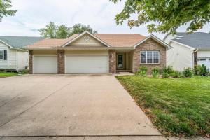a house with a driveway in front of it at Des Moines 4BR Family Getaway in Des Moines
