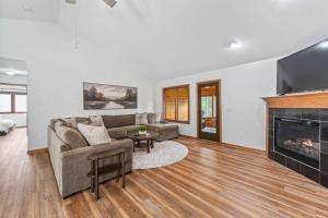 a living room with a couch and a fireplace at Des Moines 4BR Family Getaway in Des Moines