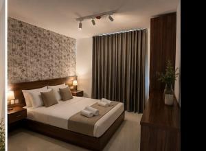 a bedroom with a bed with two towels on it at Dar Barbara Suites in Birgu
