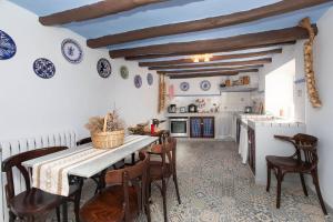 a kitchen with a table and chairs in a room at Casa rural Casa Leles in Lagata +21 photos
