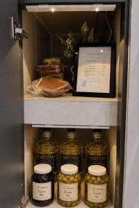a refrigerator filled with lots of jars of food at Arena Suite LR in La Rioja
