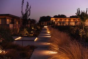 a walkway with lights in front of a building at Legado Wine Lodge in Maipú