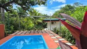 a swimming pool in the backyard of a house at Villas Pura Vida - Marañón in Puntarenas