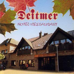 a sign for a hotel restaurant with a building at Hotel Deitmer in Rhede