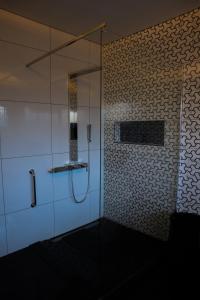 a bathroom with a shower with a glass door at Blue Crane Luxury Accommodation in Welkom