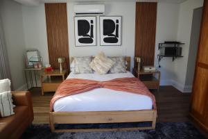 a bedroom with a bed and a couch at Blue Crane Luxury Accommodation in Welkom +10 photos