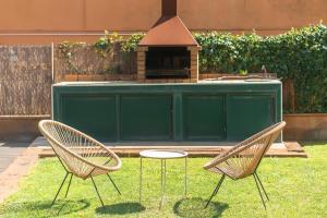 two chairs and a grill in a yard at WELCS CASA 423 PDA con piscina in Vall-Llobrega
