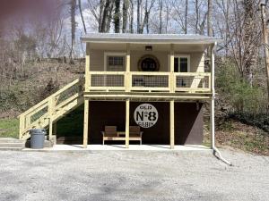a large yellow house with a sign in front of it at Old No. 8 Cabin in Alpine