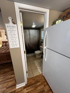 a kitchen with a refrigerator and a bathroom with a toilet at Old No. 8 Cabin in Alpine +11 photos