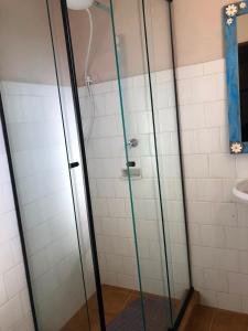 a shower with a glass door in a bathroom at Aconchego Mineiro in Visconde De Maua +35 photos